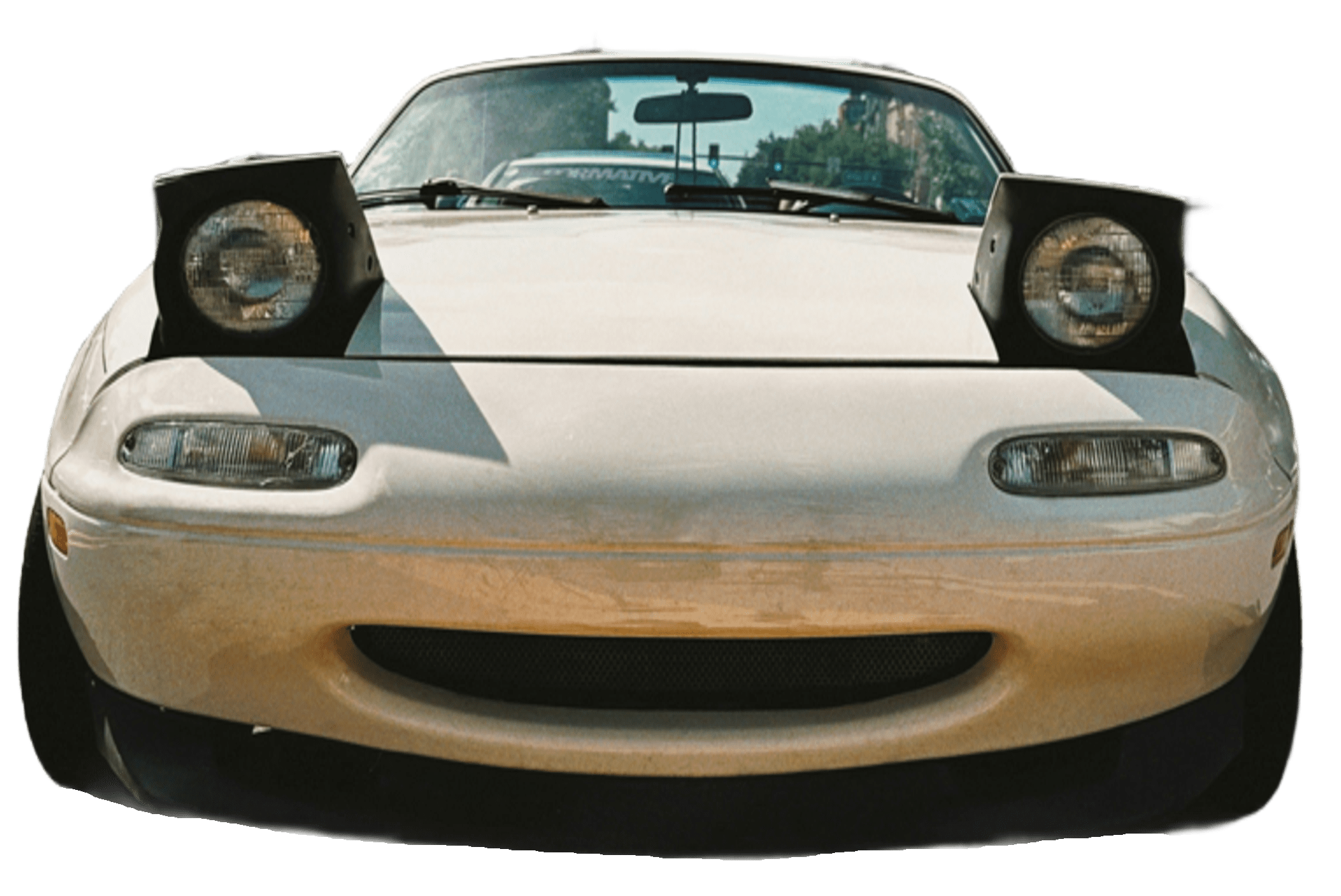 a white mazda miata with pop up headlights